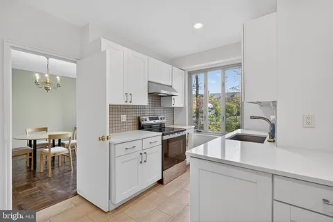 a kitchen with refrigerator cabinets and wooden floor
