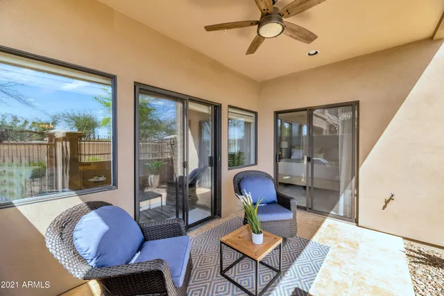 a view of a patio with table and chairs and potted plants