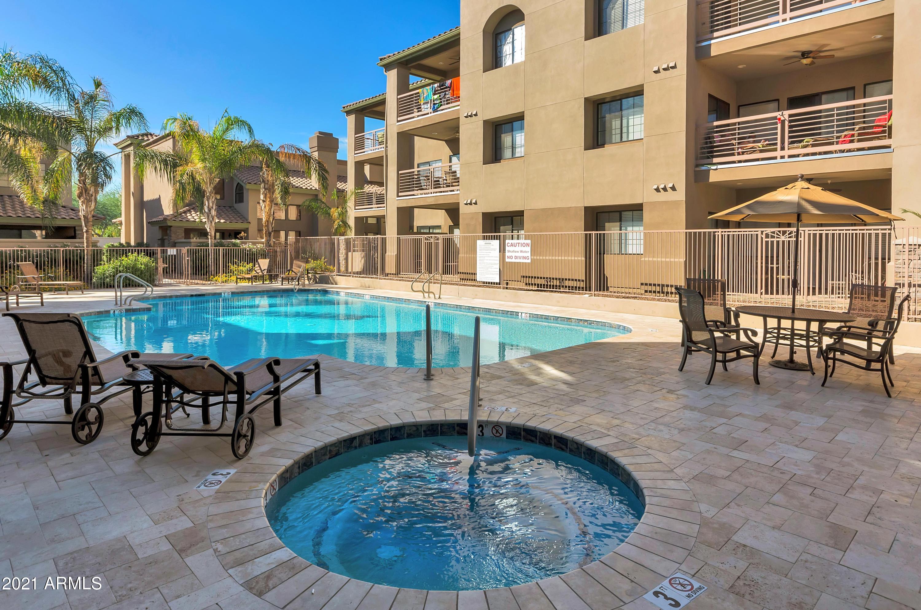 7609 East Indian Bend Road, Unit 1015 Scottsdale, AZ 85250 - Photo 26 of 30 a view of a swimming pool with outdoor seating