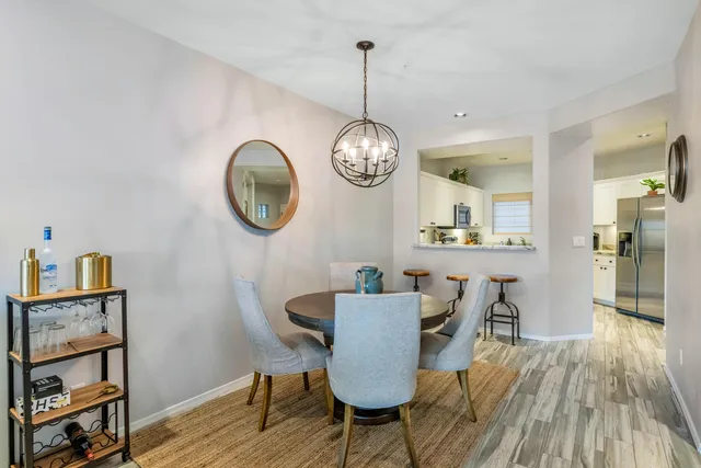 a kitchen with granite countertop a sink and white cabinets
