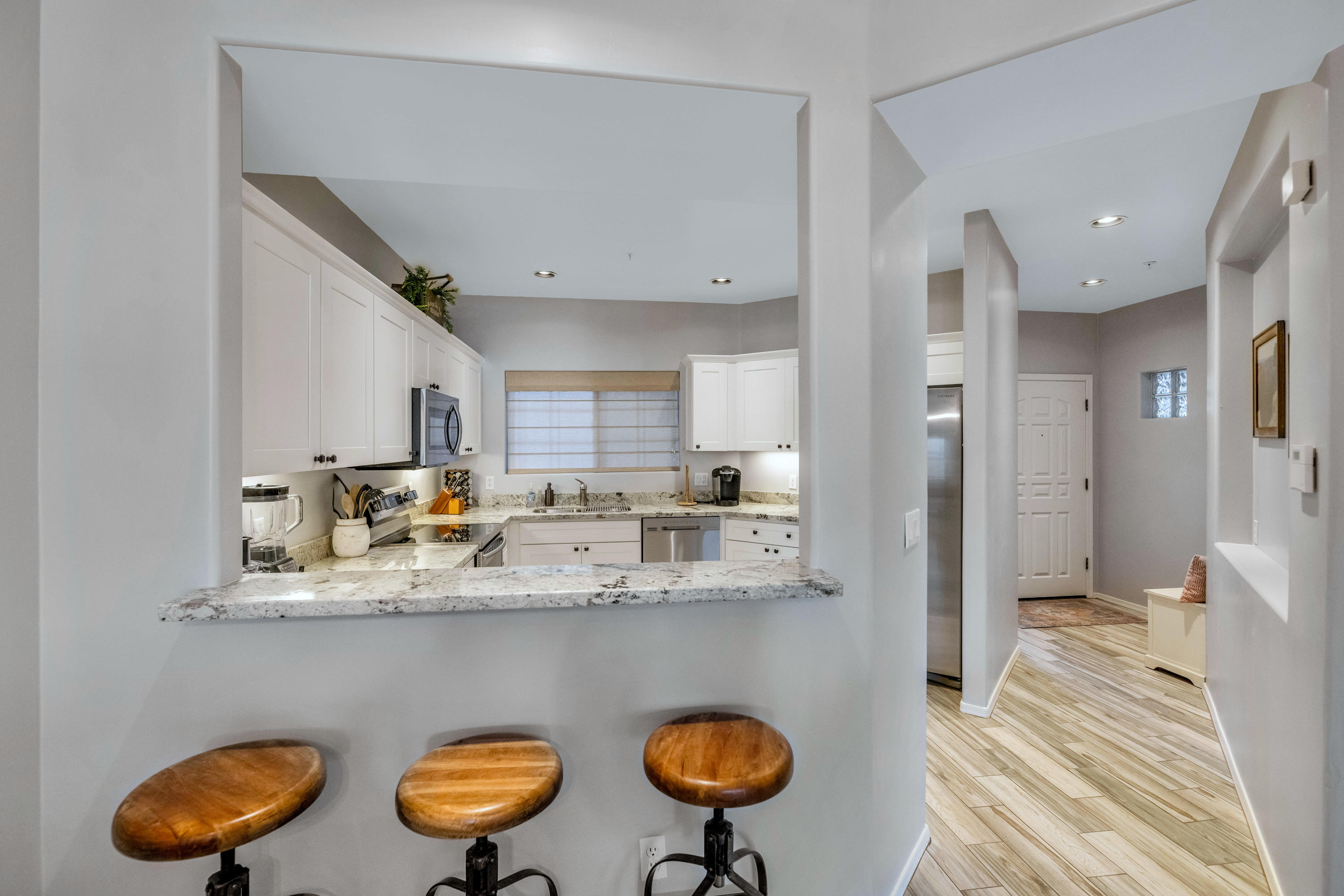 7609 East Indian Bend Road, Unit 1015 Scottsdale, AZ 85250 - Photo 4 of 30 a kitchen with stainless steel appliances granite countertop a sink and a refrigerator