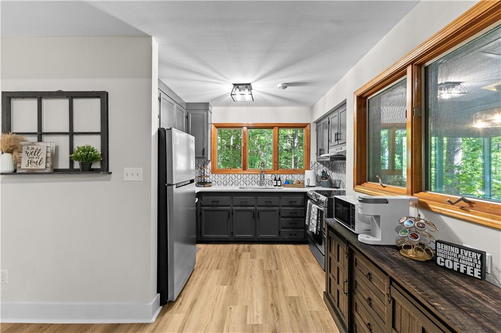 49 Baum Weg Helen, GA 30545 - Photo 16 of 47 a large kitchen with a large window and stainless steel appliances