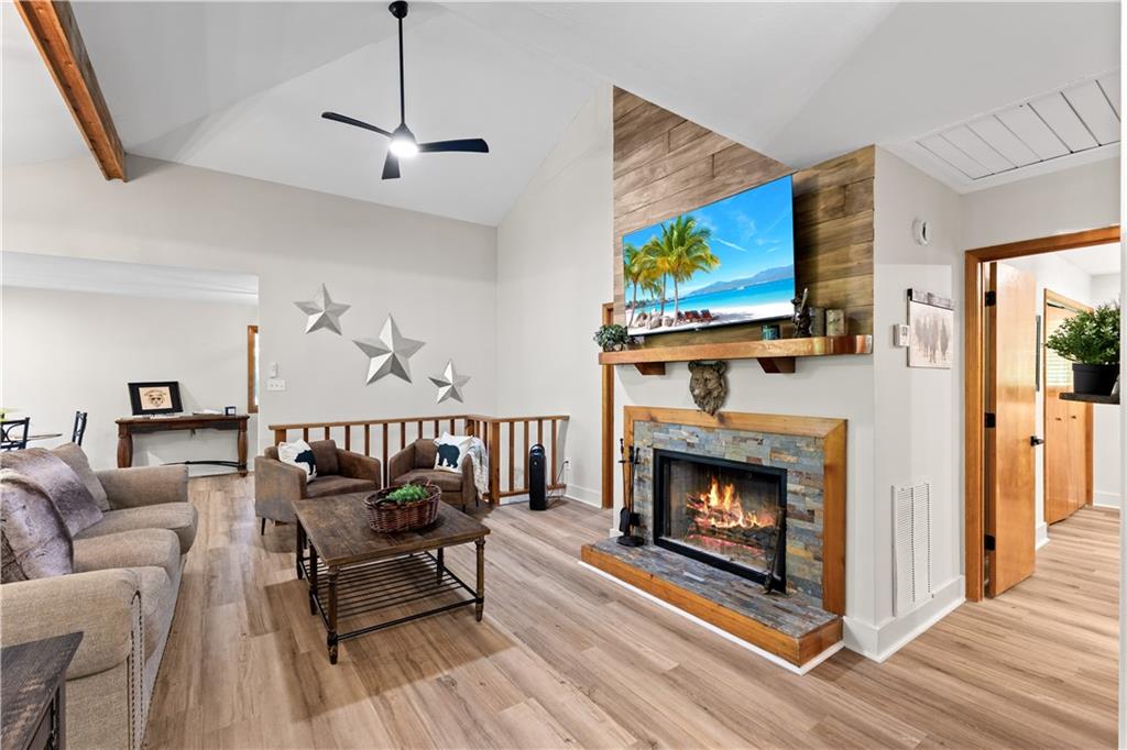 49 Baum Weg Helen, GA 30545 - Photo 2 of 47 a living room with furniture a fireplace and a flat screen tv