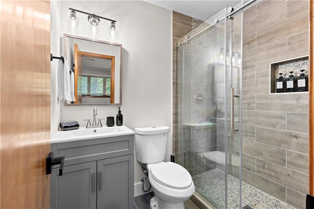 49 Baum Weg Helen, GA 30545 - Photo 29 of 47 a bathroom with a toilet sink vanity and shower