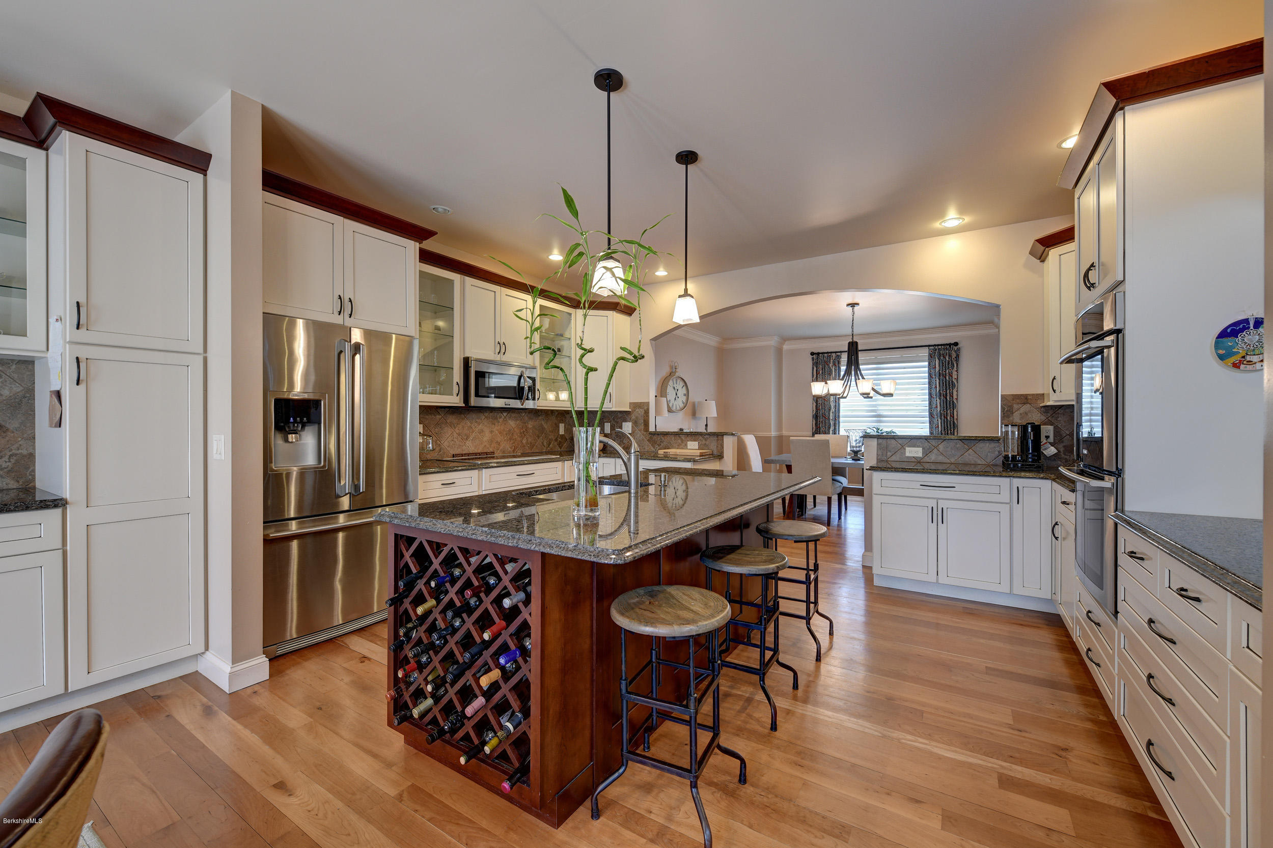 16 Lillybrook Road Pittsfield, MA 01201 - Photo 13 of 38 a kitchen with stainless steel appliances granite countertop a refrigerator a sink dishwasher a oven and a dining table with wooden floor