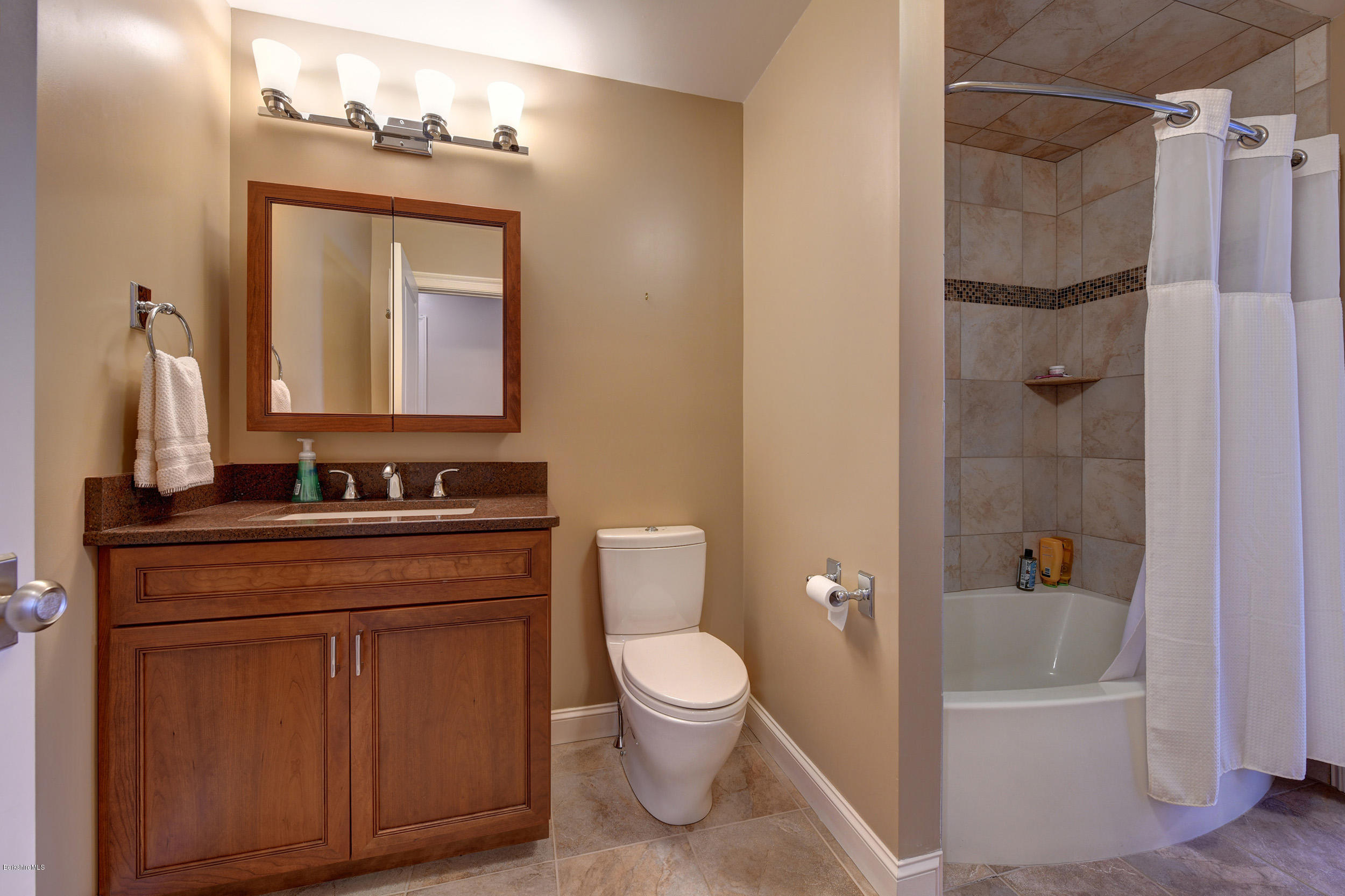 16 Lillybrook Road Pittsfield, MA 01201 - Photo 34 of 38 a bathroom with a granite countertop sink toilet a mirror and shower