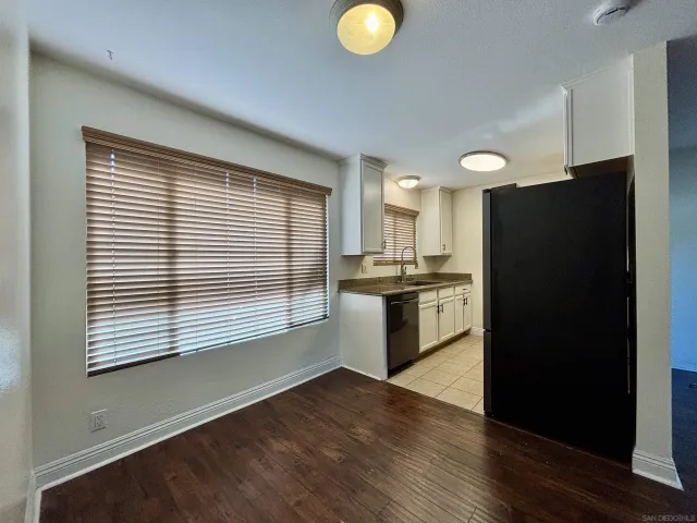 a kitchen with a refrigerator and window