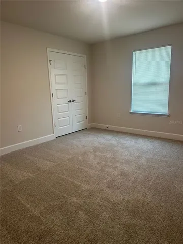 an empty room with closet and cabinet