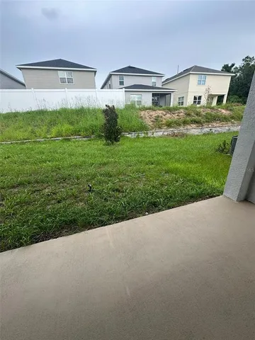 a view of a big house with big yard and plants