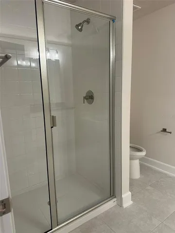 a bathroom with a shower and toilet