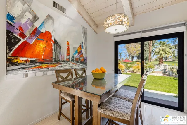 a view of a dining room with furniture window and outside view