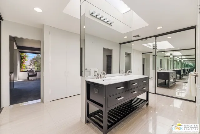 a bathroom with a double vanity sink and a mirror