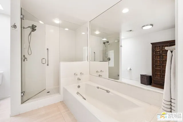 a bathroom with a bathtub and a shower