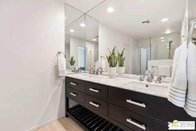 a bathroom with a double vanity sink and a mirror