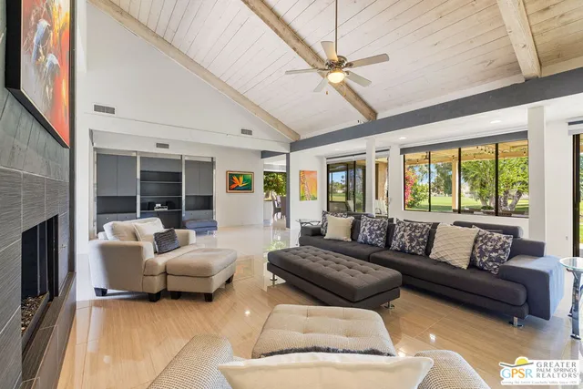 a living room with furniture and a large window