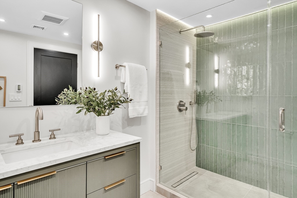 70 Birch Hill Road Belmont, MA 02478 - Photo 24 of 41 a bathroom with a shower sink and mirror