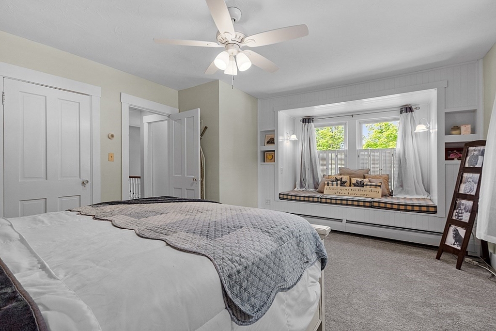 304 Patriots Road Templeton, MA 01468 - Photo 23 of 39 a spacious bedroom with a bed and a chandelier