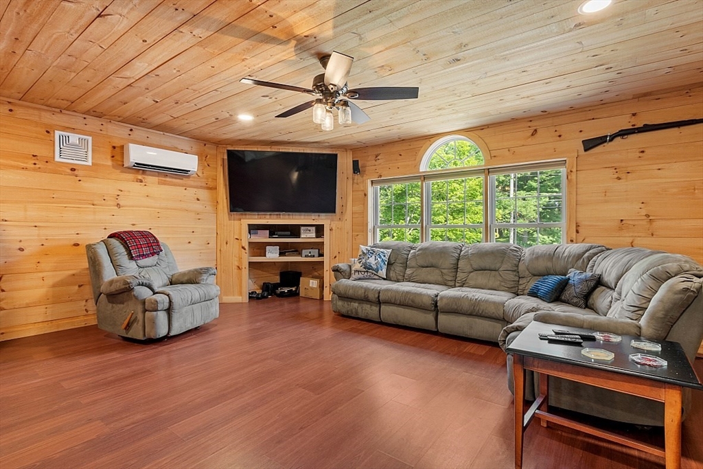 304 Patriots Road Templeton, MA 01468 - Photo 29 of 39 a living room with furniture a flat screen tv and a large window