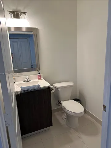 a bathroom with a sink toilet and mirror