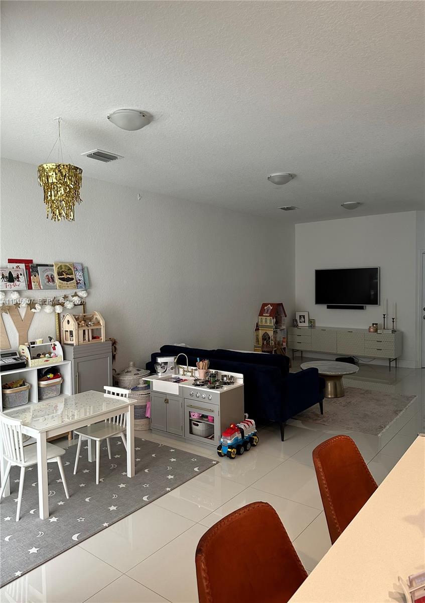 507 Southwest 91st Court, Unit 507 Miami, FL 33174 - Photo 3 of 15 a living room with furniture and a flat screen tv