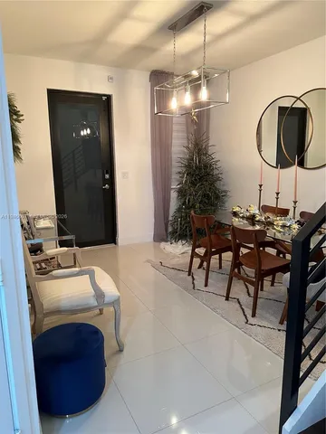 a room with a table chairs and entryway