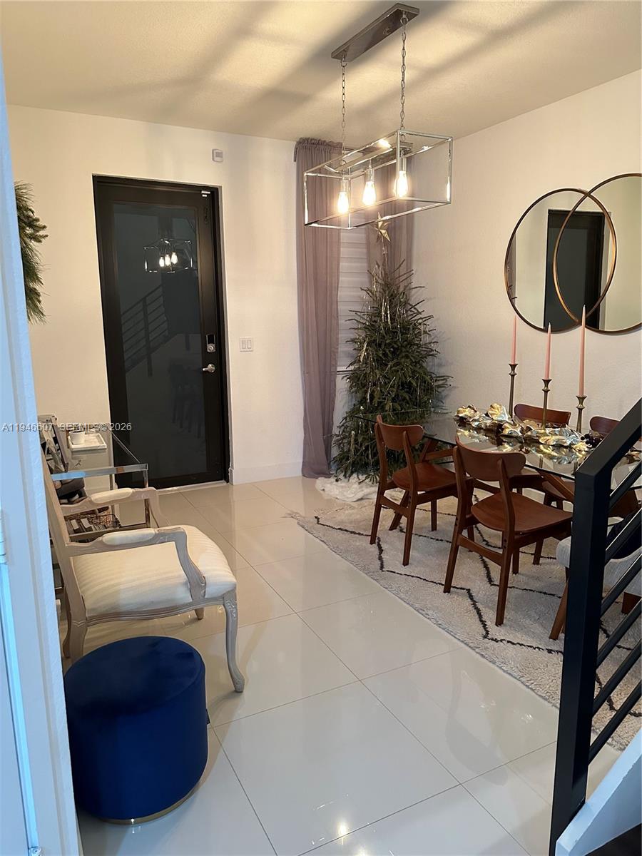 507 Southwest 91st Court, Unit 507 Miami, FL 33174 - Photo 4 of 15 a room with a table chairs and entryway