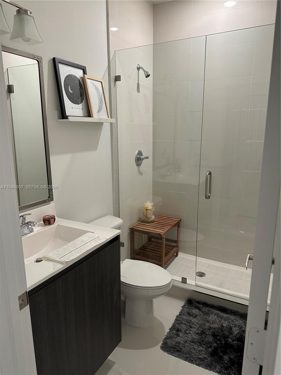 507 Southwest 91st Court, Unit 507 Miami, FL 33174 - Photo 9 of 15 a bathroom with a sink a toilet a mirror and shower