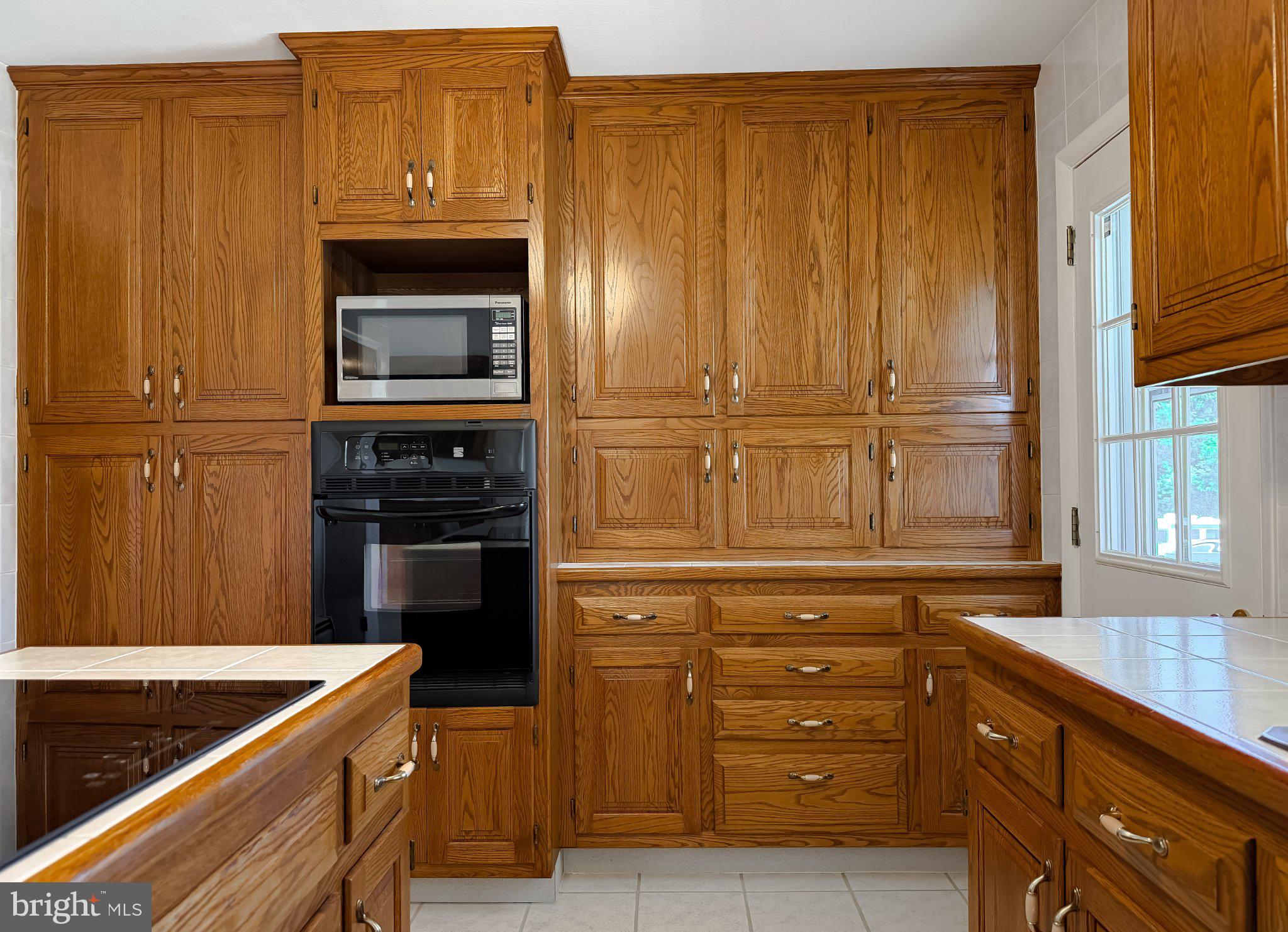 23230 Colton Point Road Avenue, MD 20609 - Photo 17 of 63 Warm oak cabinetry in a bright kitchen.