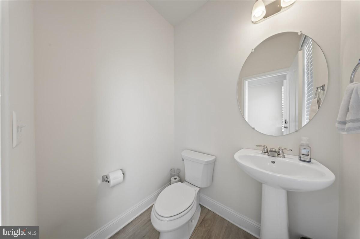 38023 Cross Gate Road Millville, DE 19967 - Photo 11 of 37 a bathroom with a toilet sink and mirror