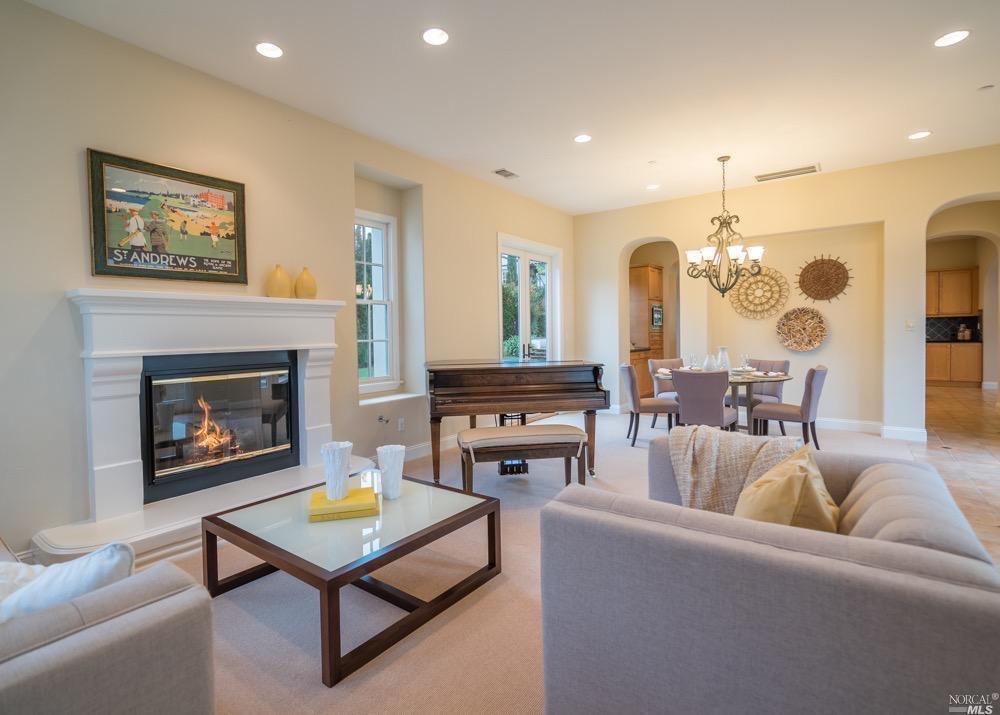 105 Chapel Hill Road Novato, CA 94949 - Photo 1 of 1 Formal living/dining area with gas fireplace and plenty of light from 3 sets of french doors leading to yard and central courtyard.