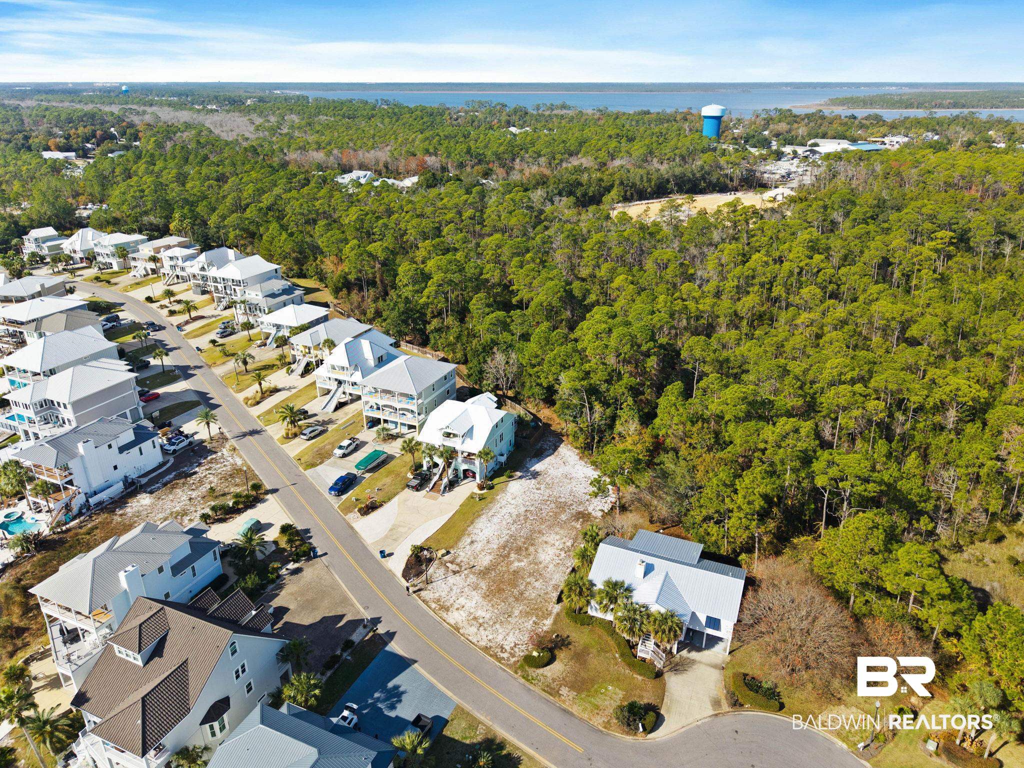 4143 Harbor Road Orange Beach, AL 36561 - Photo 15 of 33 Aerial view of property and surrounding area featuring nearby suburban area and a nearby body of water