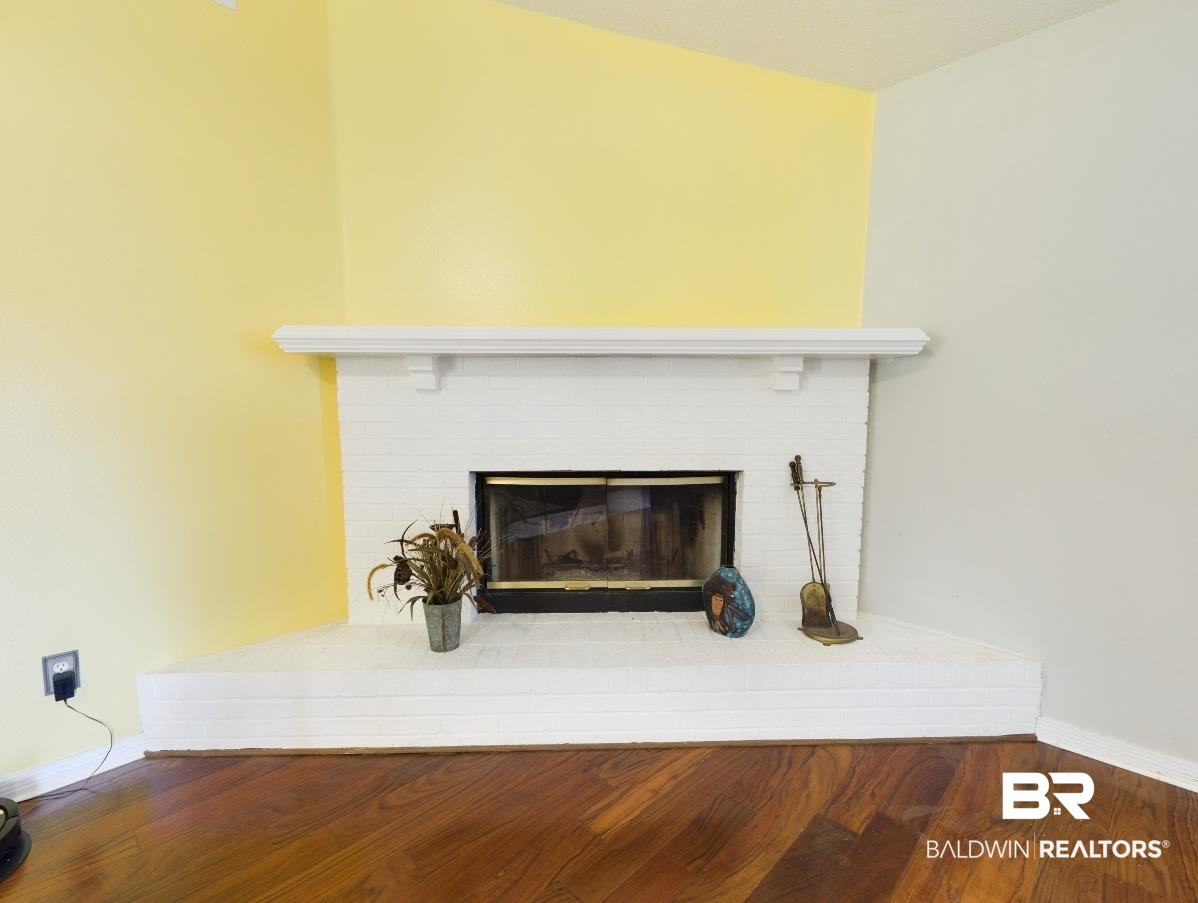 14313 Hemley Road Coden, AL 36523 - Photo 2 of 44 Room details featuring wood-type flooring and a fireplace