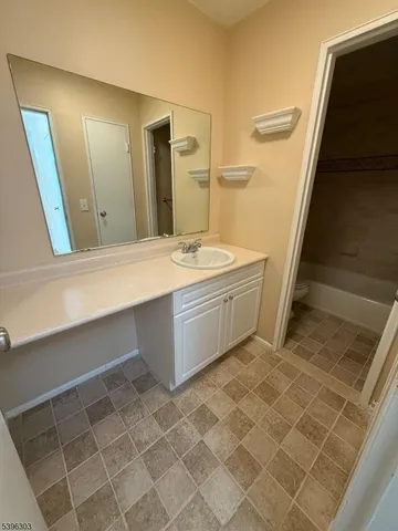 a bathroom with a sink a mirror and a bathtub