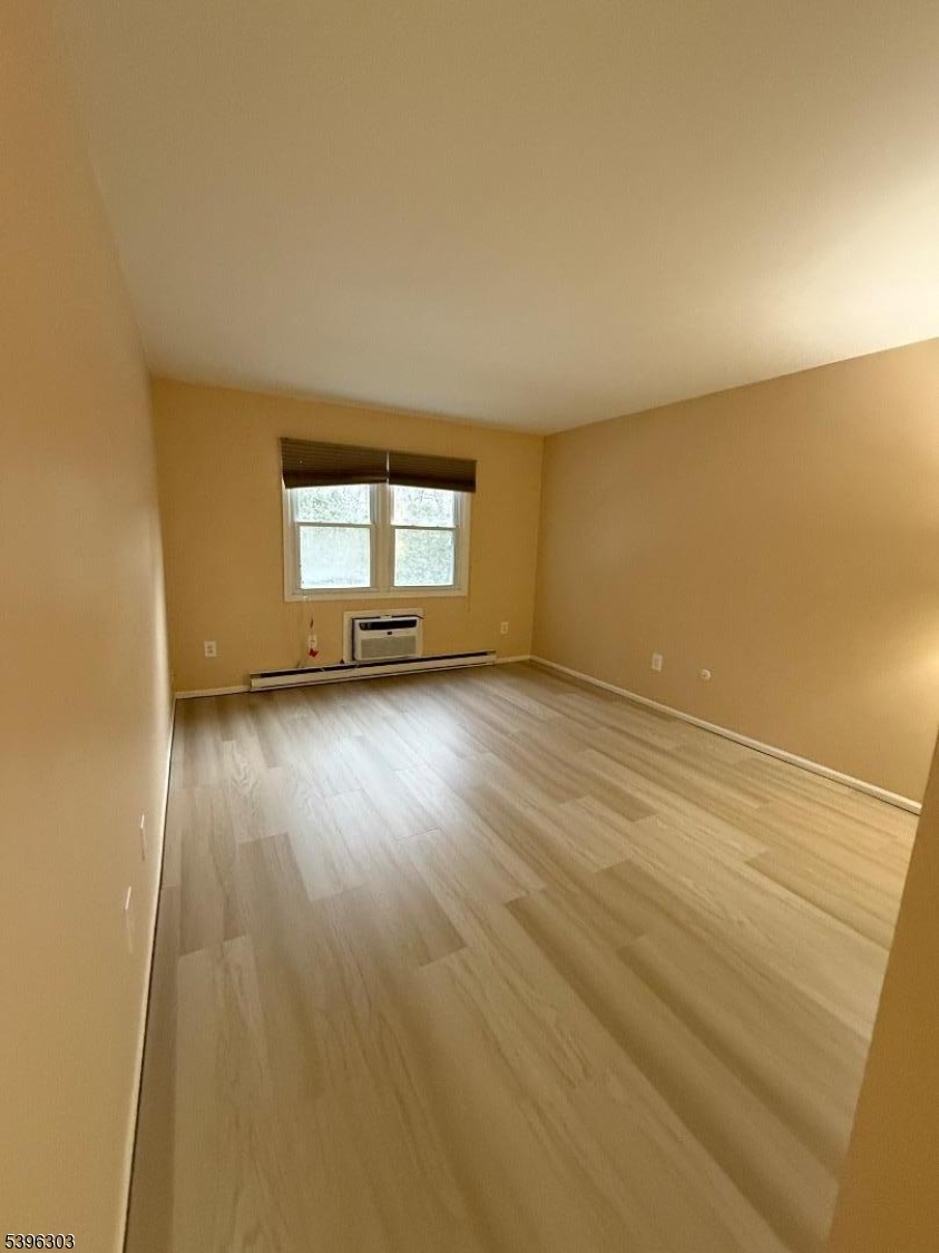 680 Highway 15, Unit 41 Lake Hopatcong, NJ 07849 - Photo 12 of 18 an empty room with wooden floor and windows