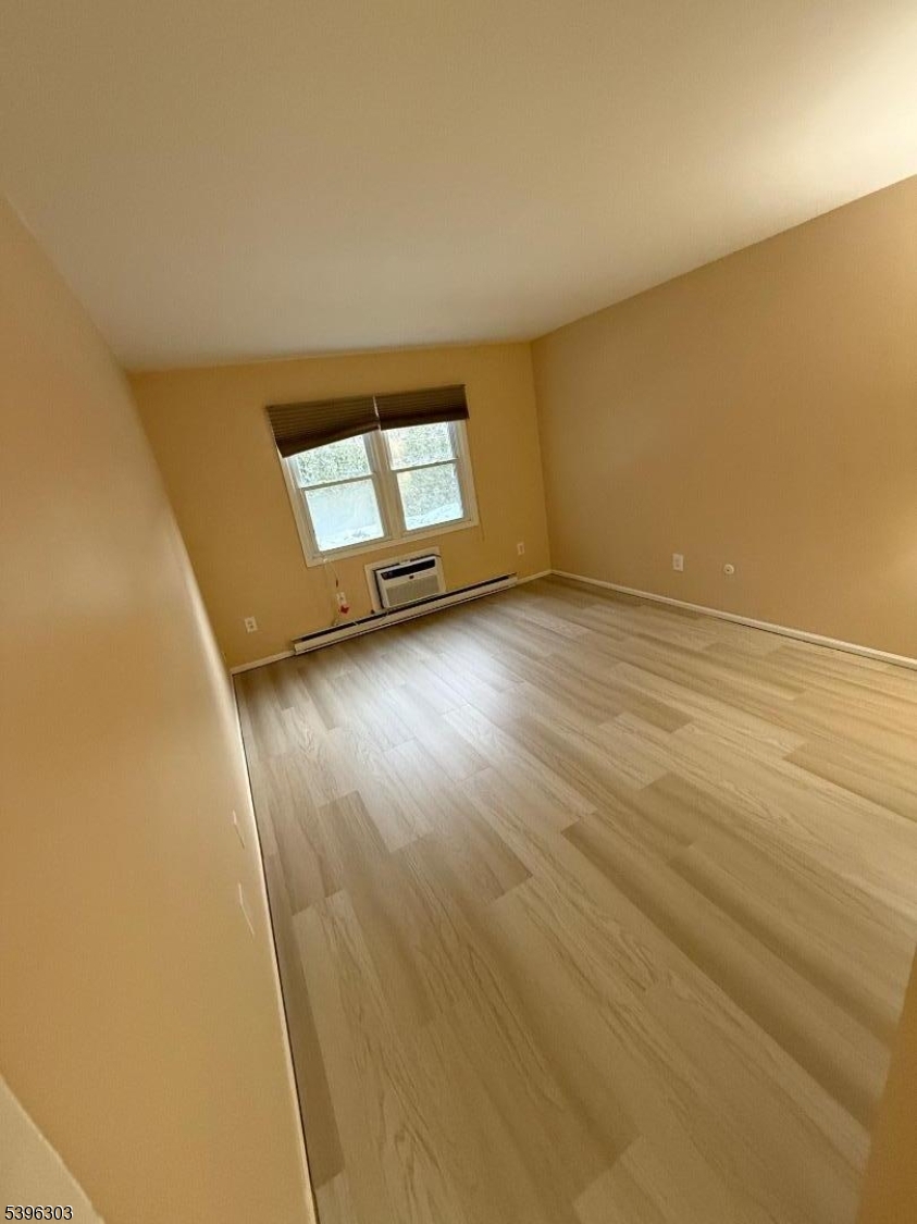 680 Highway 15, Unit 41 Lake Hopatcong, NJ 07849 - Photo 13 of 18 an empty room with wooden floor and windows