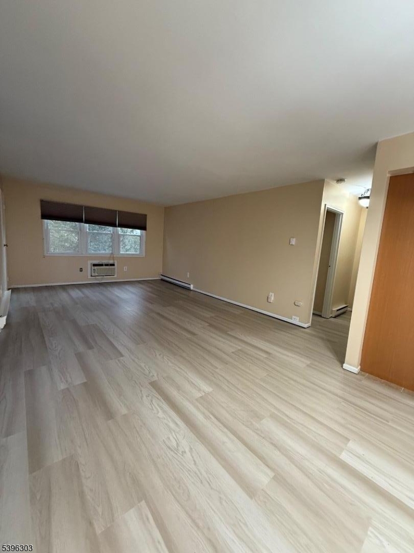 680 Highway 15, Unit 41 Lake Hopatcong, NJ 07849 - Photo 16 of 18 an empty room with wooden floor and window