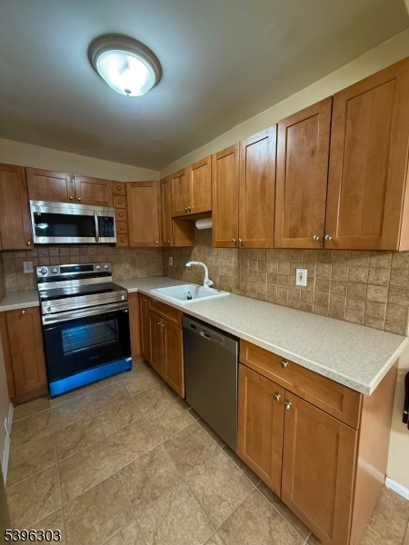 680 Highway 15, Unit 41 Lake Hopatcong, NJ 07849 - Photo 5 of 18 a kitchen with a sink stove and microwave