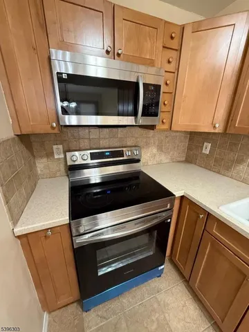 a stove top oven sitting inside of a kitchen