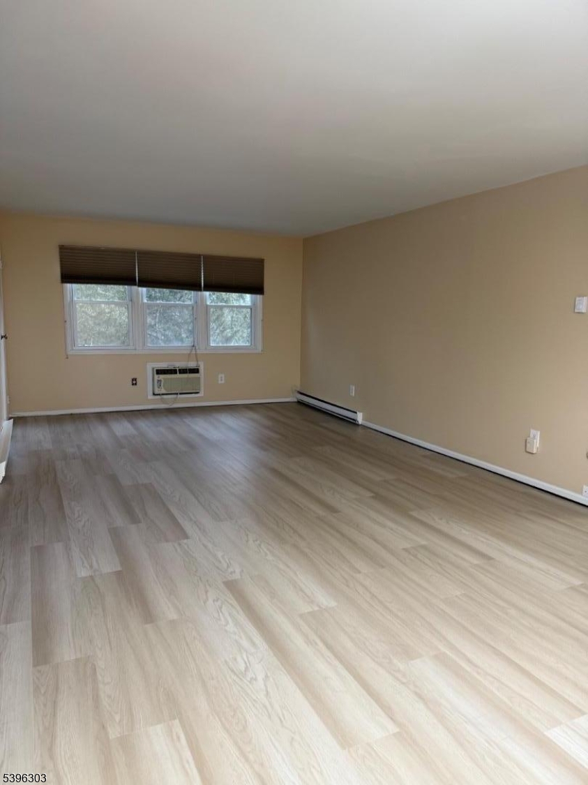 680 Highway 15, Unit 41 Lake Hopatcong, NJ 07849 - Photo 10 of 18 an empty room with wooden floor and windows