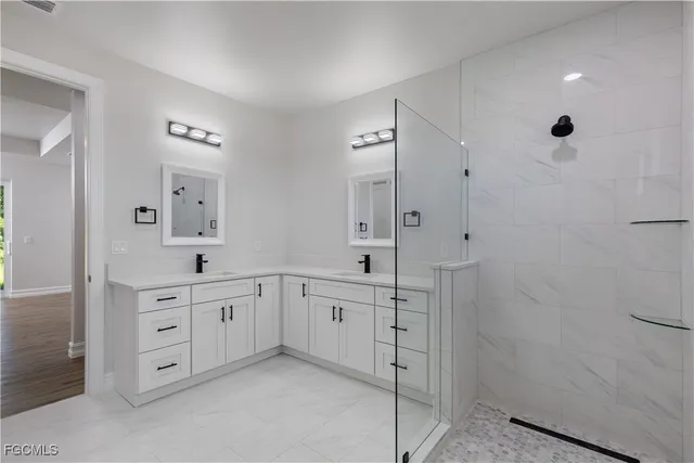 a spacious bathroom with a granite countertop sink a mirror and a