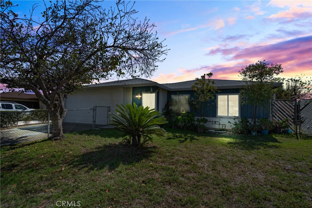 407 West Woodcrest Street Rialto, CA 92376 - Photo 1 of 1 a yellow house with garden in front of it
