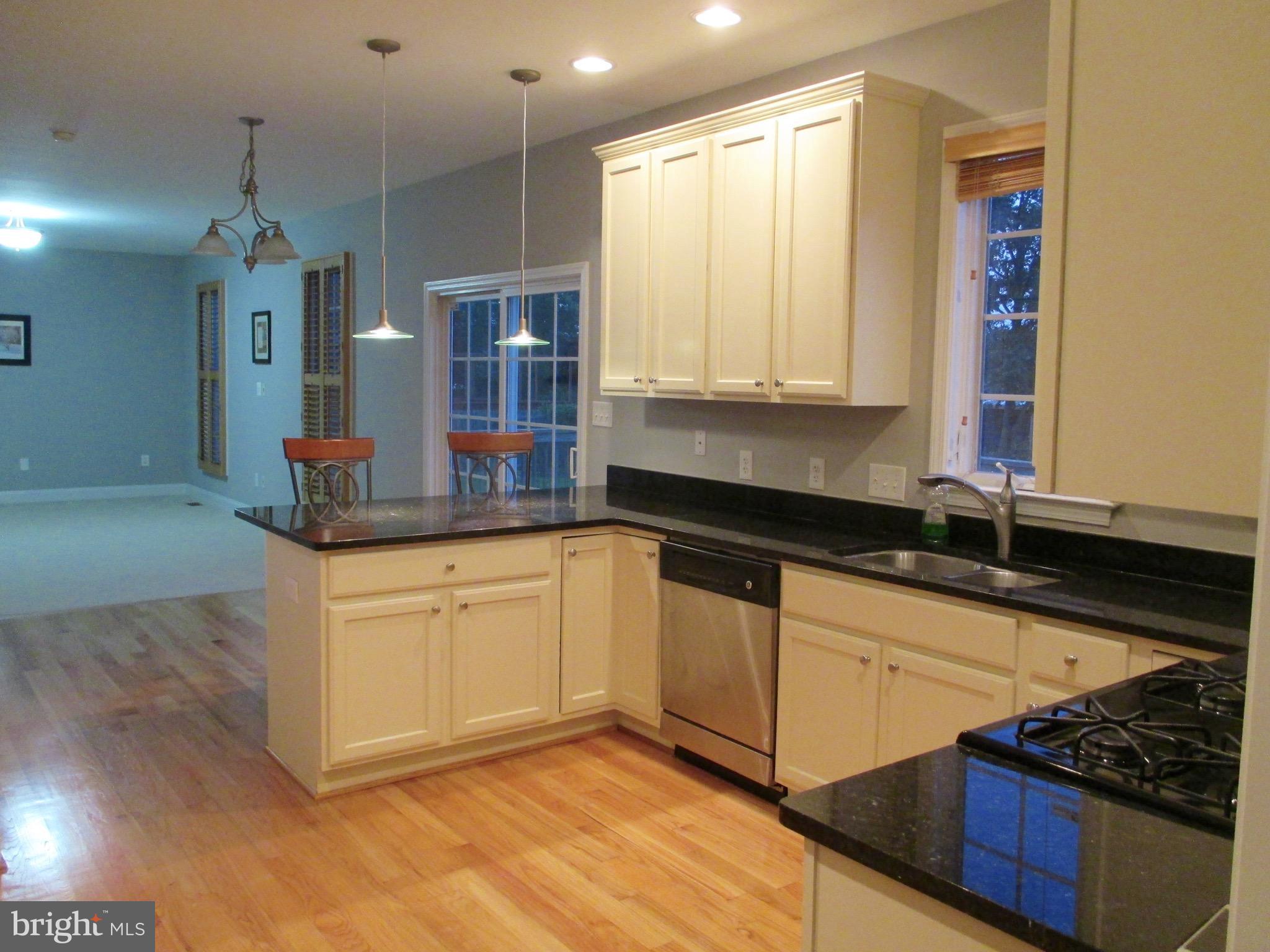 6300 Lincolnia Road Alexandria, VA 22312 - Photo 6 of 30 a kitchen with stainless steel appliances granite countertop a stove a sink and a microwave