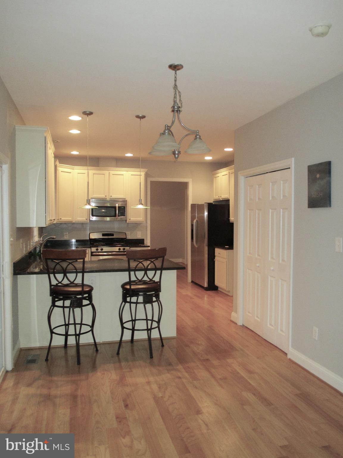 6300 Lincolnia Road Alexandria, VA 22312 - Photo 7 of 30 a view of a kitchen with dining table and chairs