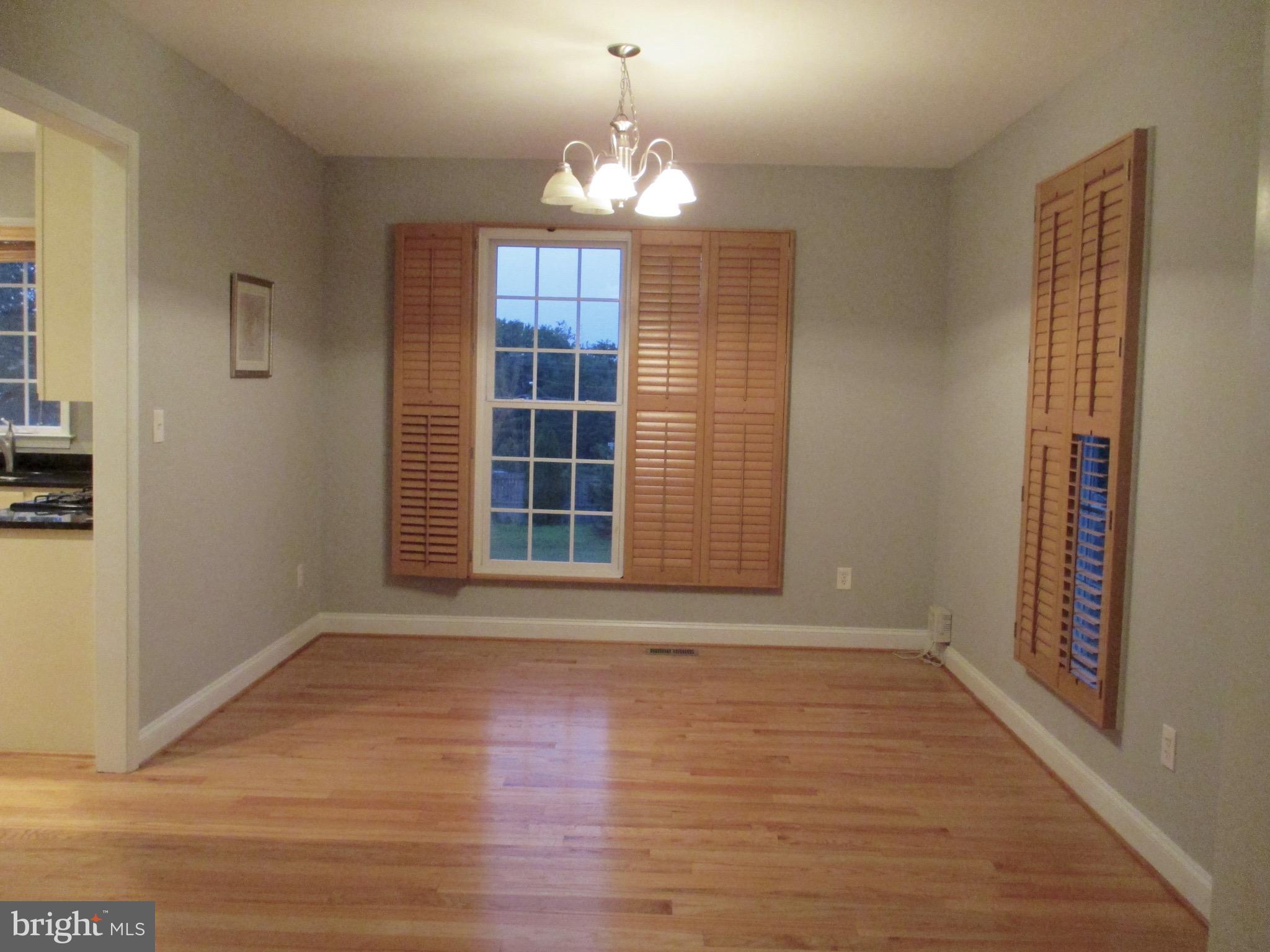 6300 Lincolnia Road Alexandria, VA 22312 - Photo 9 of 30 a view of an empty room with wooden floor and a window