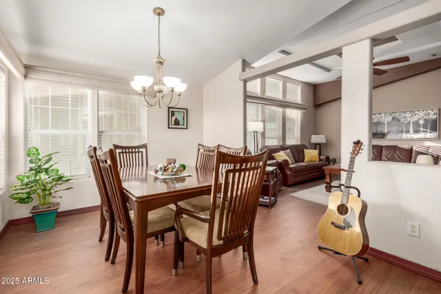 a view of a dining room with furniture and a chandelier