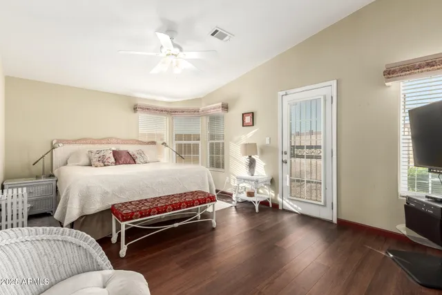 a bedroom with bed and wooden floor