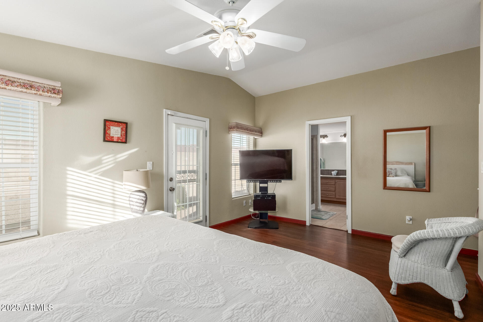 11201 North El Mirage Road, Unit F16 El Mirage, AZ 85335 - Photo 15 of 29 a bedroom with a bed and a flat screen tv