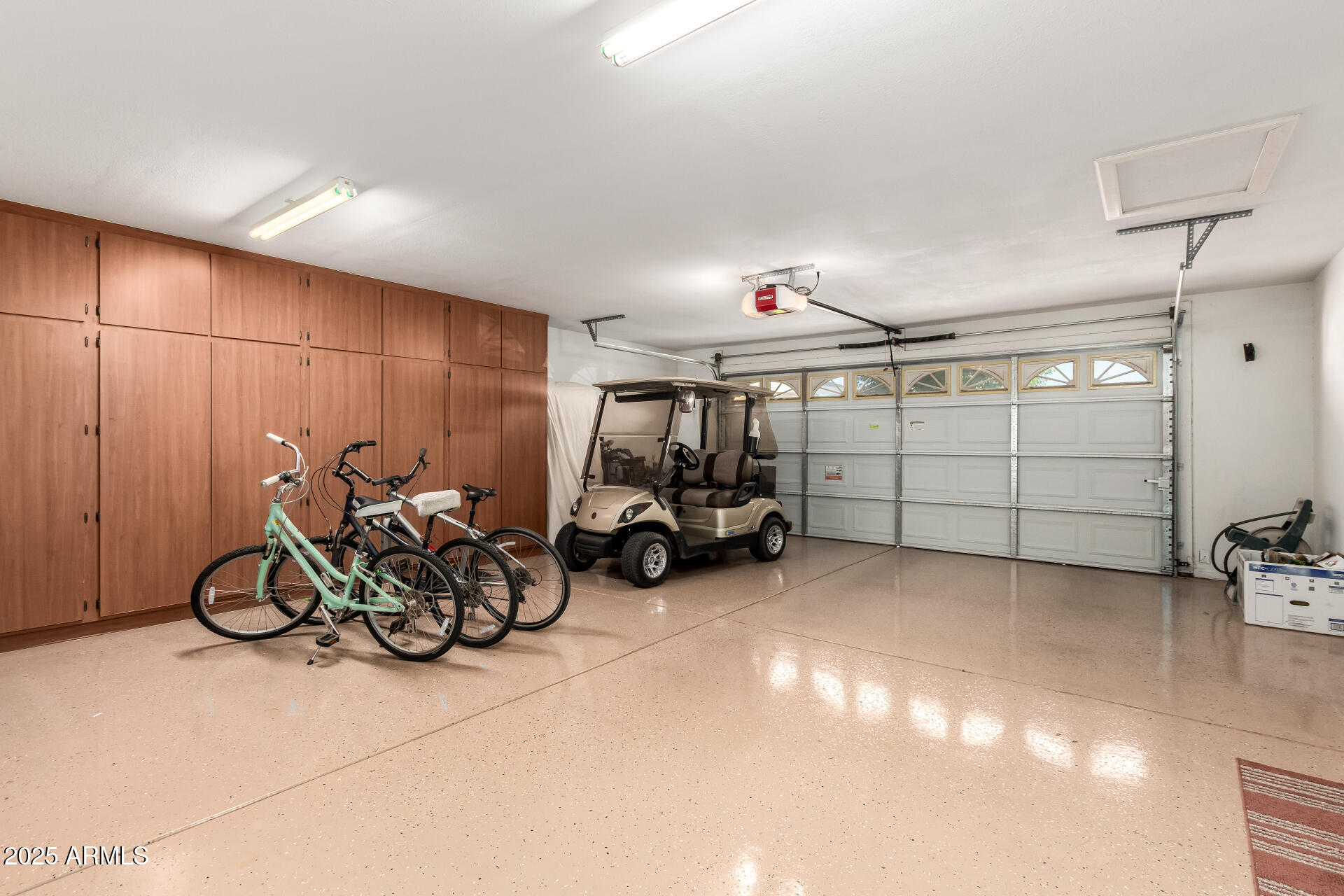 11201 North El Mirage Road, Unit F16 El Mirage, AZ 85335 - Photo 26 of 29 a view of a garage with a table and a chair