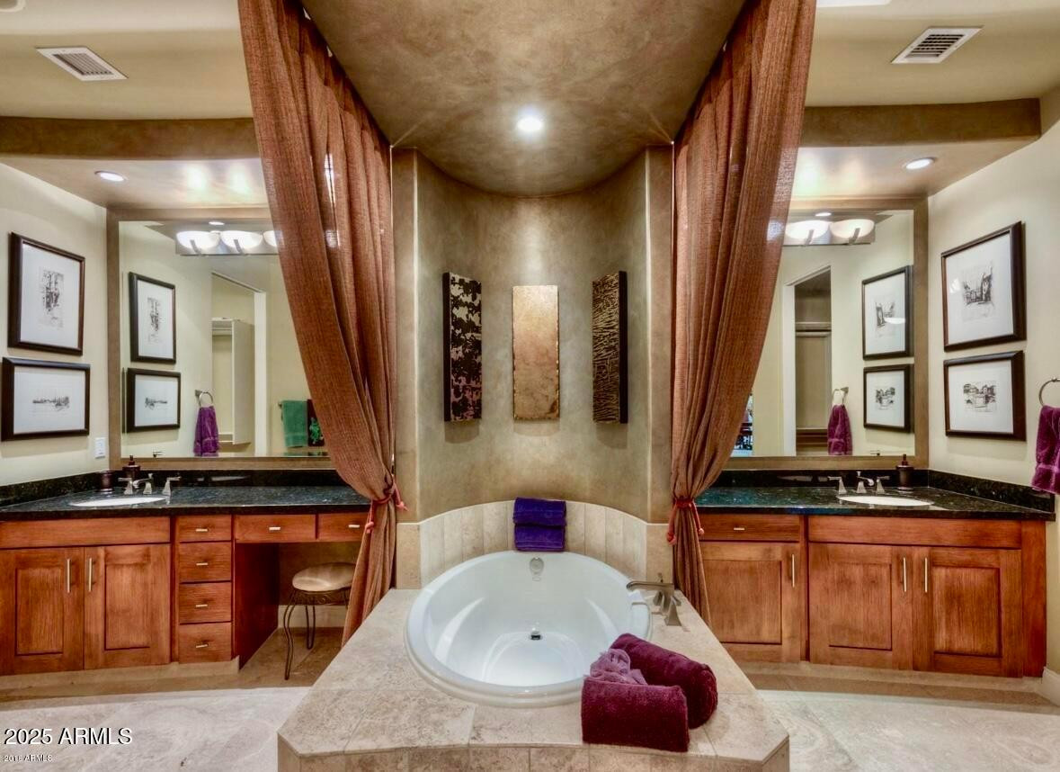 8 Biltmore Estate, Unit 112 Phoenix, AZ 85016 - Photo 11 of 14 a bathroom with a sink and a mirror