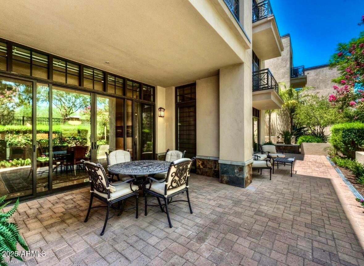 8 Biltmore Estate, Unit 112 Phoenix, AZ 85016 - Photo 14 of 14 a view of a patio with a dining table and chairs